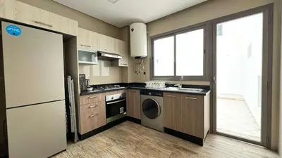 a kitchen with a refrigerator and a washer and dryer at Maarif 6TH Floor with 3 Bedrooms - AppartAli in Casablanca
