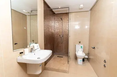 a bathroom with a sink and a shower and a toilet at Maarif 6TH Floor with 3 Bedrooms - AppartAli in Casablanca