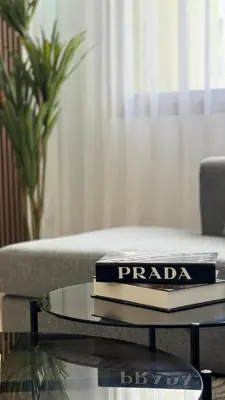 a stack of books on a coffee table in a living room at Maarif 6TH Floor with 3 Bedrooms - AppartAli in Casablanca