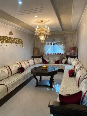 a large living room with couches and a table at Airport house hotel in Derroua