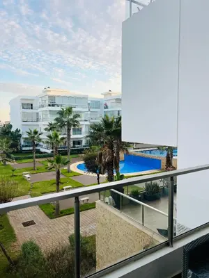 a view of the pool from the balcony of a resort at Seaside studio with pool in Dar Bouazza