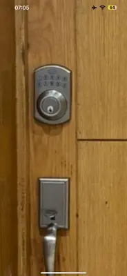 a wooden door with a door knob and aperature at Seaside studio with pool in Dar Bouazza