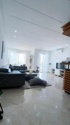a large living room with couches and a couch at Seaside studio with pool in Dar Bouazza