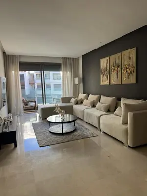 a living room with a couch and a table in it at Sublime Résidence - Dreamy Appartment 1BR in Maarif