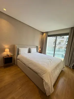 a bedroom with a large bed with a large window at Sublime Résidence - Dreamy Appartment 1BR in Maarif