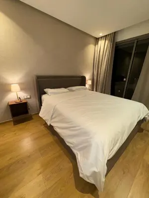 a bedroom with a large bed with white sheets at Sublime Résidence - Dreamy Appartment 1BR in Maarif