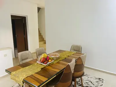 a dining room table with a bowl of fruit on it at villa azur in Dar Bouazza