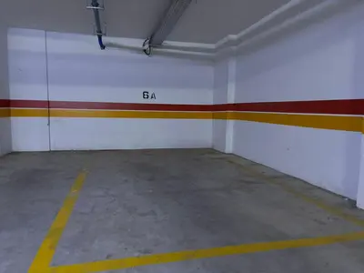 an empty garage with a red and white wall at Bouskoura, appart jardin privé in Casablanca