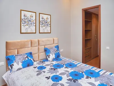 a bedroom with a bed with blue and gray pillows at Nexthouse in Casablanca