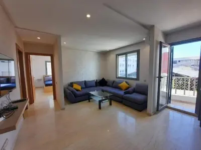 a living room with a blue couch with yellow pillows at Studio Haut Standing, Prix Doux ! in Casablanca