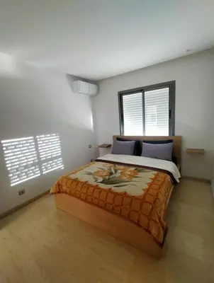 a bedroom with a large bed with blue pillows at Studio Haut Standing, Prix Doux ! in Casablanca