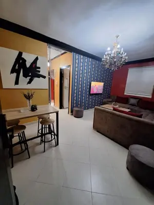 a living room with a couch and a table at charmant appart à Mohammedia in Mohammedia