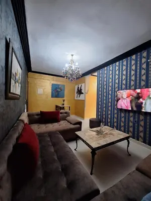 a living room with a couch and a table at charmant appart à Mohammedia in Mohammedia