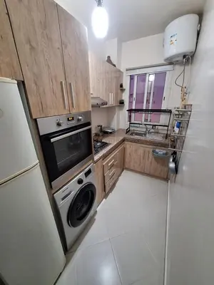 a kitchen with a washer and dryer in it at charmant appart à Mohammedia in Mohammedia
