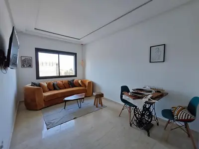 a living room with a couch and a table at Anchor point in Dar Bouazza