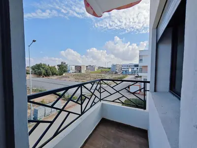 a balcony with a view of a city at Anchor point in Dar Bouazza
