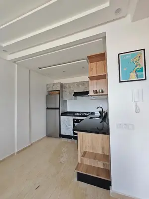 a room with a kitchen with a stove at Anchor point in Dar Bouazza