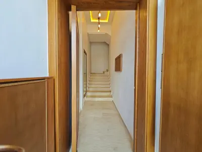 a hallway with a long hallway with a long aisle at Anchor point in Dar Bouazza