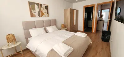 a bedroom with a large white bed in a room at One-Five Racine by IB Signature, Stylish 2BR Apt, 24x7 Security, WiFi, Self check-in, City View, City Centre, close to cafes and restaurants in Casablanca