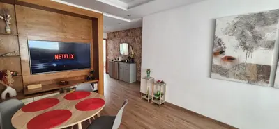 a living room with a table and a tv at One-Five Racine by IB Signature, Stylish 2BR Apt, 24x7 Security, WiFi, Self check-in, City View, City Centre, close to cafes and restaurants in Casablanca