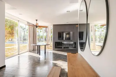 a living room with a table and a mirror at Villa Luxueuse 4 Chambres au Cœur du Domaine a El Menzeh in El Menzeh