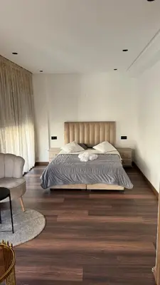 a bedroom with a large bed and a couch at Studio luxueux à Maarif in Casablanca
