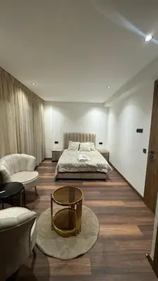 a bedroom with a bed and a couch and a table at Studio luxueux à Maarif in Casablanca