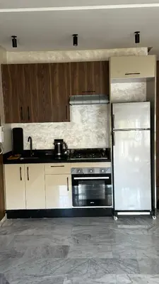a kitchen with a stove and a refrigerator at Studio luxueux à Maarif in Casablanca
