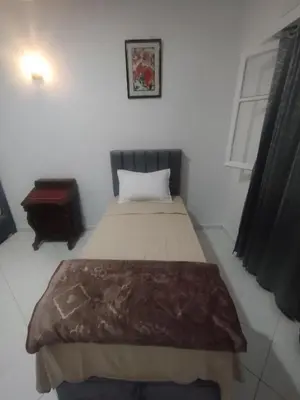 a small bedroom with a bed and a window at Appartement au centre de Rabat Agdal in Rabat