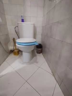a bathroom with a toilet in a tiled room at Appartement au centre de Rabat Agdal in Rabat