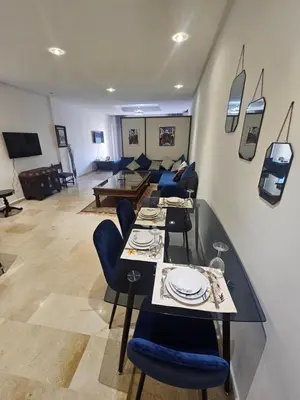 a living room with a table and chairs and a couch at Studio spacieux plein centre in Casablanca