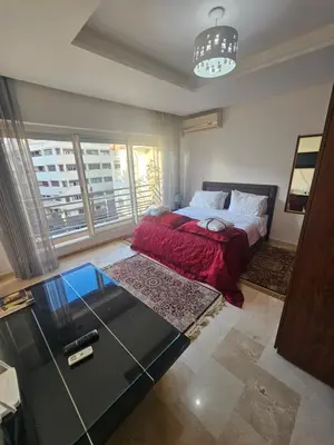 a bedroom with a bed with a red blanket at Studio spacieux plein centre in Casablanca