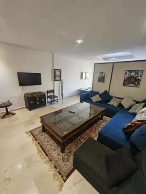 a living room with a blue couch and a coffee table at Studio spacieux plein centre in Casablanca