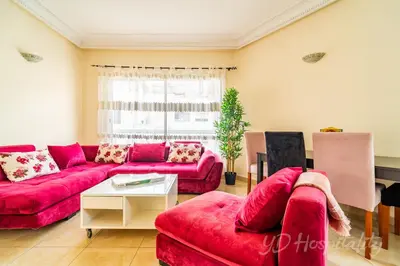 a living room with two red couches and a table at Gauthier 5-Star Luxury Gem in Casablanca