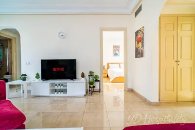 a living room with a tv on a white wall at Gauthier 5-Star Luxury Gem in Casablanca