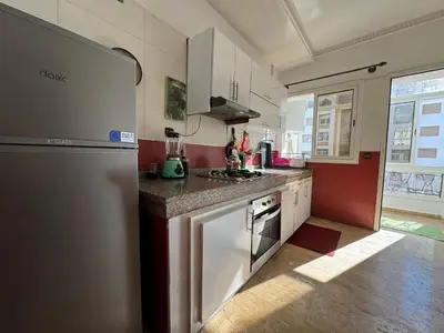 a kitchen with a refrigerator and a counter top at Appartement exceptionnel en plein centre de rabat pour les familles et couples mariés in Rabat