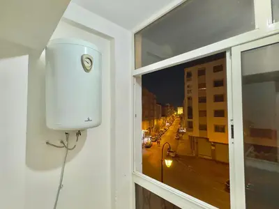 a window with a white tank on the side of a building at Appartement exceptionnel en plein centre de rabat pour les familles et couples mariés in Rabat