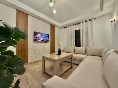 a living room with a couch and a table at Appartement exceptionnel en plein centre de rabat pour les familles et couples mariés in Rabat