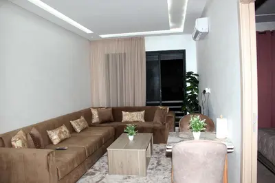 a living room with a couch and a table at cosy studio au coeur de casablanca in Maarif