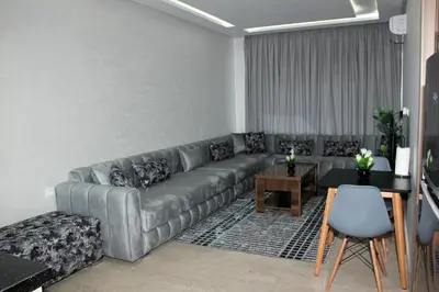 a living room with a couch and a table at cosy studio au coeur de casablanca in Maarif