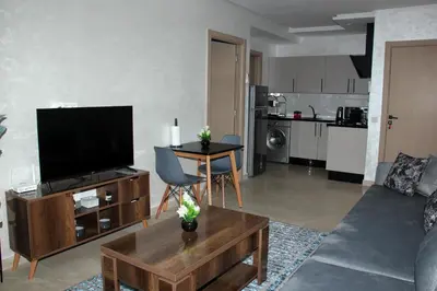 a living room with a couch and a tv at cosy studio au coeur de casablanca in Maarif