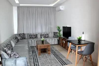 a living room with a couch and a table at cosy studio au coeur de casablanca in Maarif