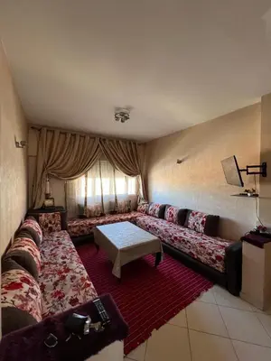 a living room with a couch and a table at Appartement à Ain Sebaa proche de tous les commodites in Casablanca