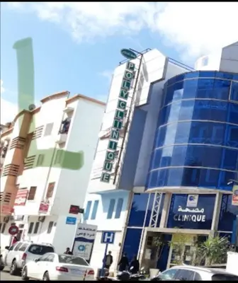 a large building with cars parked in front of it at Appartement à Ain Sebaa proche de tous les commodites in Casablanca