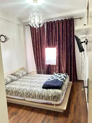 a bedroom with a bed in front of a window at Appartement à Ain Sebaa proche de tous les commodites in Casablanca