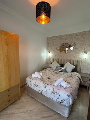 a bedroom with a bed with towels on it at AnfaSuites - Le Central - Parking Free - CasaPort 5min in Casablanca