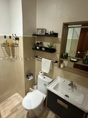 a bathroom with a toilet and a sink at AnfaSuites - Le Central - Parking Free - CasaPort 5min in Casablanca