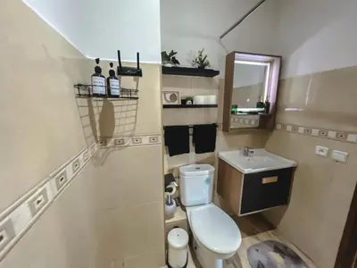 a small bathroom with a toilet and a sink at AnfaSuites - Le Central - Parking Free - CasaPort 5min in Casablanca