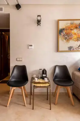 two black chairs and a table in a room at Casa Lilas Free Parking & Gym & Optical Fiber Oldtown 5 mn Walk in Rabat