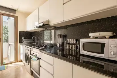 a kitchen with white cabinets and a microwave at Casa Lilas Free Parking & Gym & Optical Fiber Oldtown 5 mn Walk in Rabat
